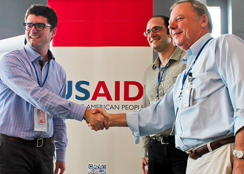 USAID Maximizing Agricultural Revenue through Knowledge, Enterprise Development and Trade project’s Chief of Party Tim Moore (left) congratulates Gerald Knecht, CEO of P.T. Bali Seafood (right) and David Solomon, CEO of Pelagic Data Systems. Credit: USAID