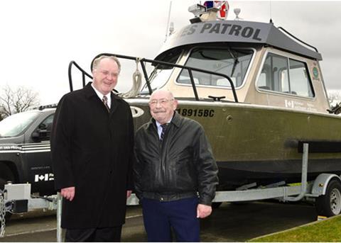 Fisheries and Oceans Minister, Keith Ashfield, with retired fishery officer, Max Tscharre, beside the Max Bay. The vessel was named after Mr Tscharre.