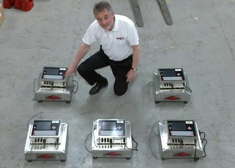 Nesco’s Gordon Norman with the batch of machines prior to dispatch