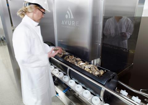 The Avure 100L HPP system with a basketful of oysters going in to the machine. The 100L can process 800-850kg of oysters or mussels per hour. Credit: Avure