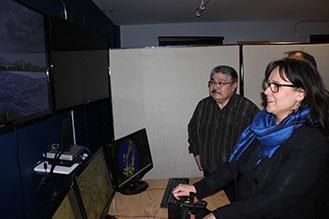 Leona Aglukkaq, Minister of the Environment, Minister of CanNor, and Minister for the Arctic Council, operates the marine training simulator at Nunavut Arctic College